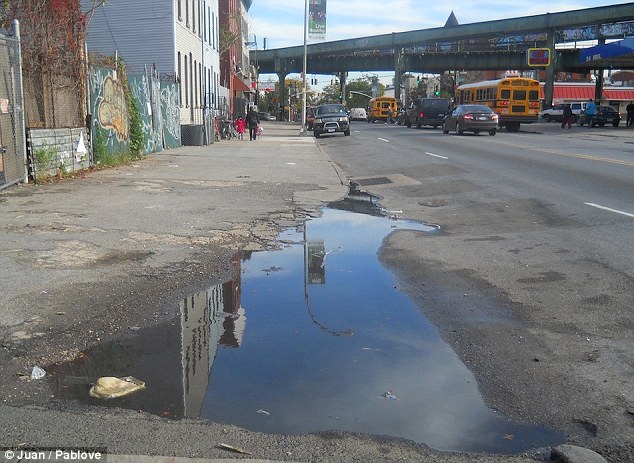 On reflection: This shot of an uninspiring New York road, by Juan, 13, is given beauty by the blue sky reflecting in the puddle