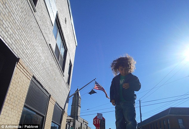 Looking up: Antonella, age 7, cleverly uses perspective to capture this image of a child with the American flag waving in the background