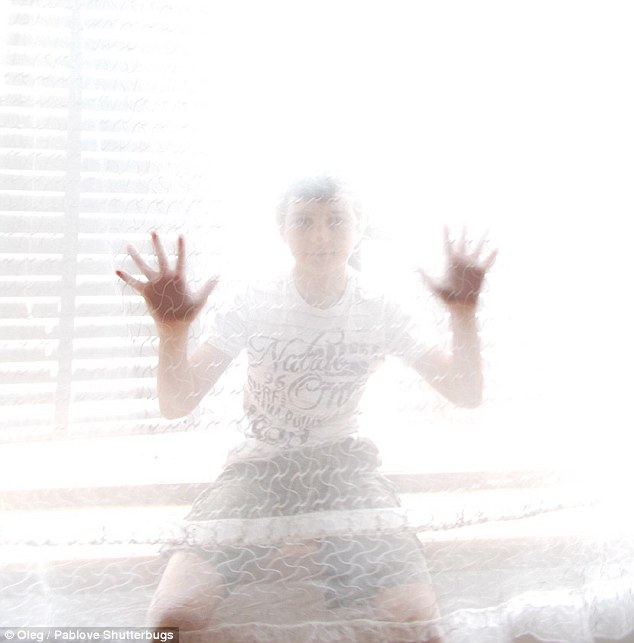 Strike a pose: Oleg, 13, took a picture of a friend who is obscured by a curtain