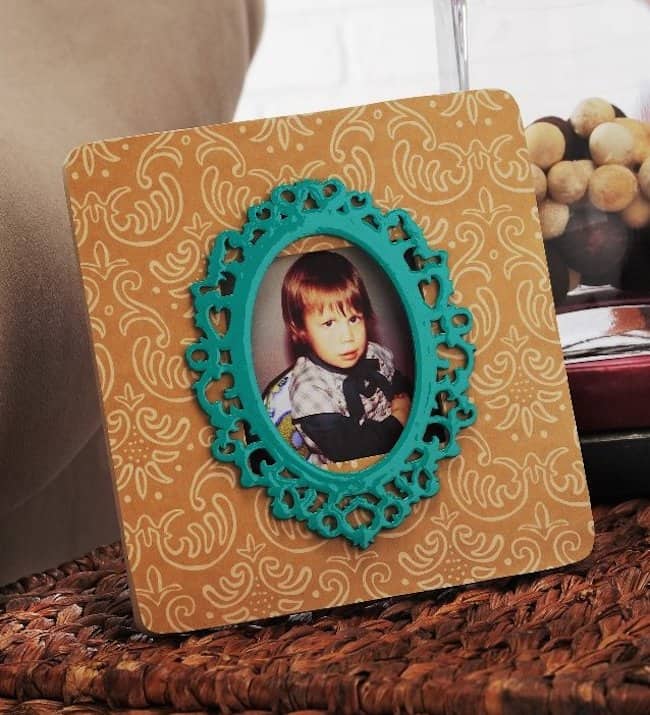 Create a decoupage frame masterpiece by adding a damask accent to a wood frame found at the craft store for $1. Use your favorite paper and Mod Podge.