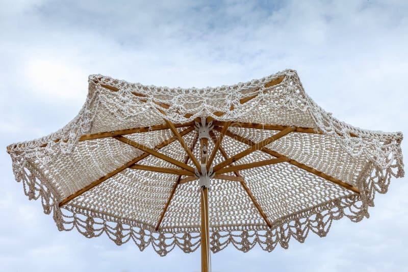 Beach crochet Umbrella. Unusual creative luxury umbrella for garden, pool, and beach stock images
