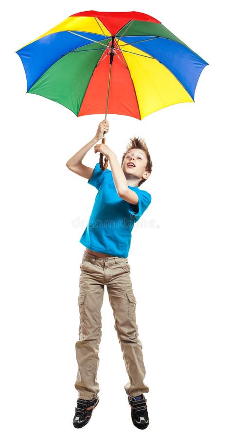 Beautiful funny boy in t-shirt flying with a multicolored umbrella. Beautiful funny boy boy in red t-shirt holding a multicolored umbrella flying carried by the royalty free stock images