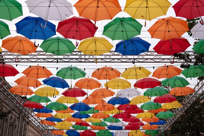 Funny multi-colored decorative umbrellas in the sky decorating a tourist street in St. Petersburg. Unusual street decorations royalty free stock images