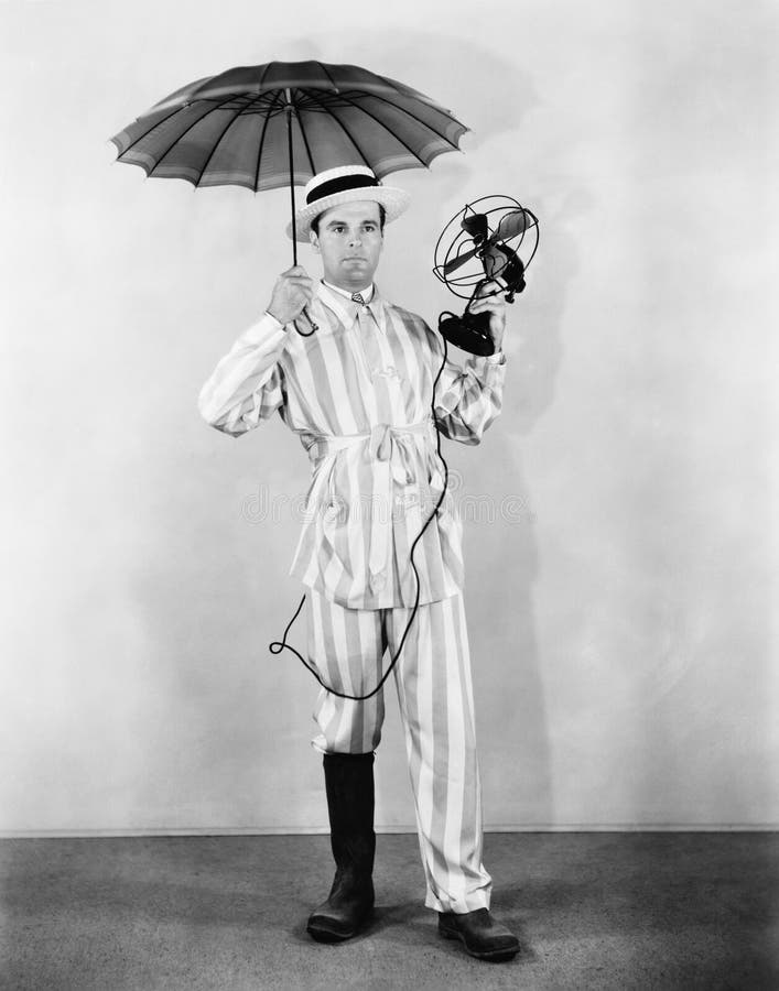 The weather man with umbrella, boot and fan. (All persons depicted are no longer living and no estate exists. Supplier grants that there will be no model royalty free stock photos