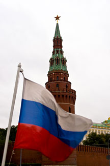 Russia flag with Kremlin in background